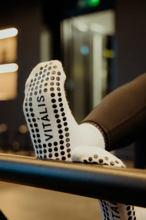 Vitális branded grip socks on a reformer