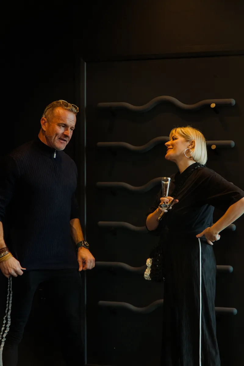 Guests laughing together at the grand opening