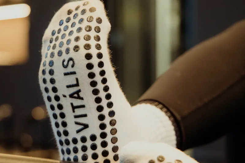 Vit&aacute;lis grip socks on the reformer foot bar