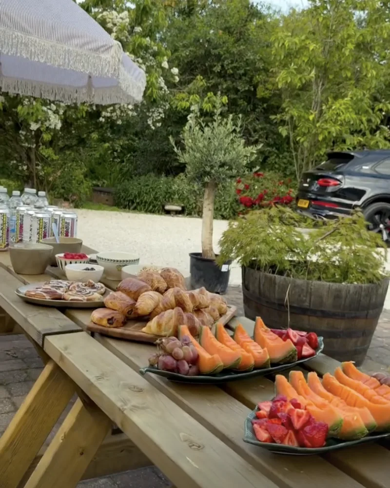 Outdoor breakfast spread of fresh pastries and fruit at the retreat