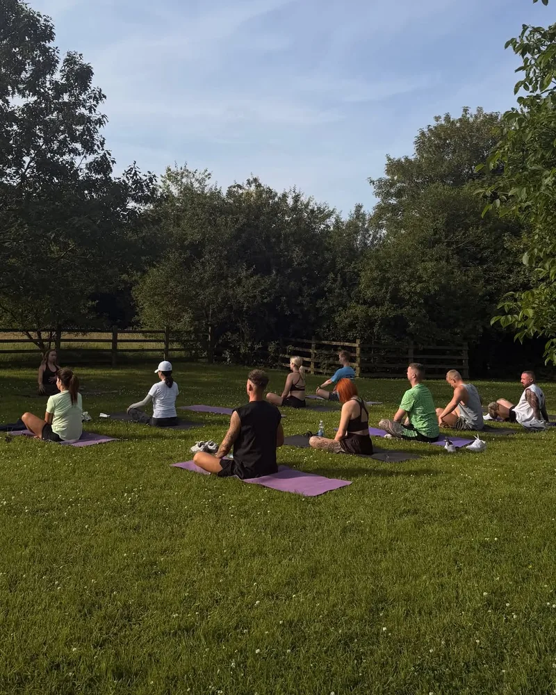 Group yoga session on the lawn at the Vitális retreat