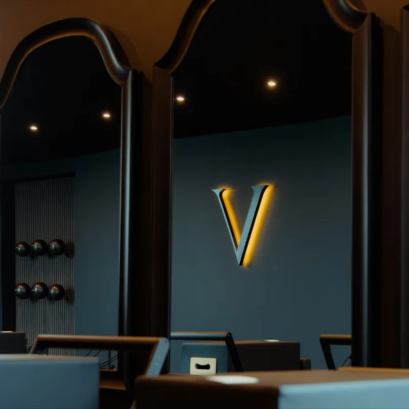 Vitális Studios interior with gold V sign and reformer beds